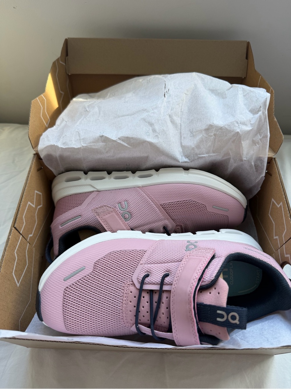 On Running cloud Kids Sneaker in Pink with Navy Accents. In box